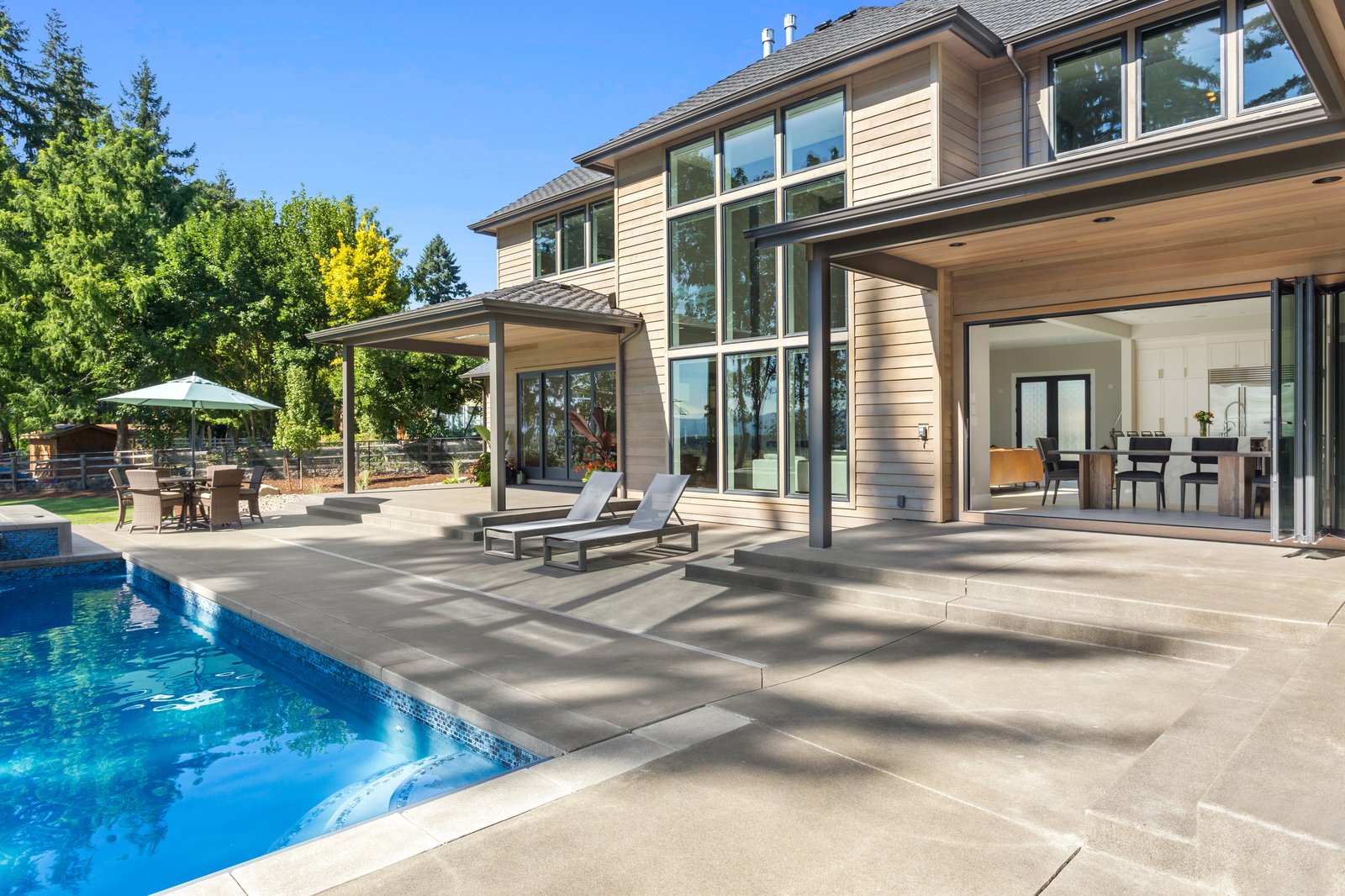 Forestview + Estate modern home pool deck wide by Reschka Design Build